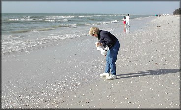 Betsy Lyerly on the beach near the Sanibel Lighthouse